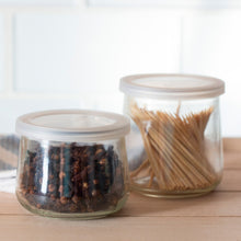Clear, unlabeled Oui by Yoplait yogurt jars used to store peppercorns and toothpicks.

