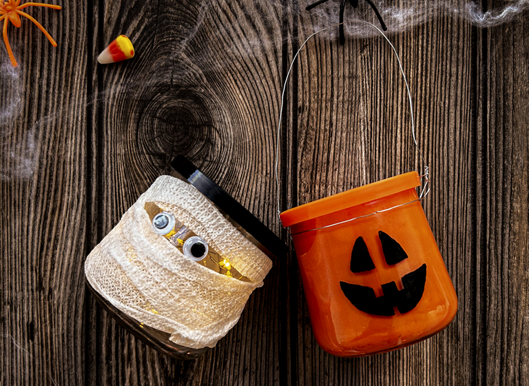 Oui by Yoplait yogurt jars decorated as a mummy and jack-o'-lantern for Halloween.